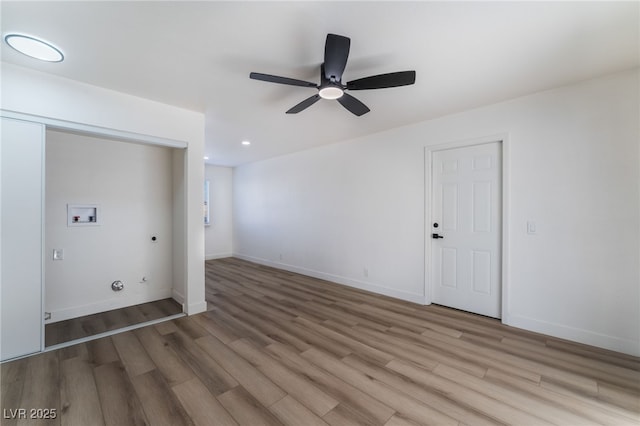 empty room with ceiling fan and light hardwood / wood-style floors