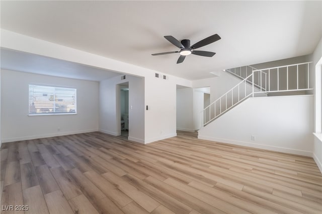 unfurnished living room with ceiling fan and hardwood / wood-style floors