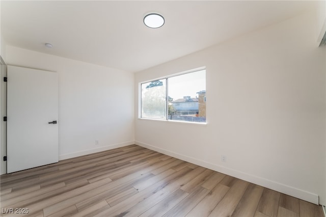 spare room featuring light hardwood / wood-style flooring