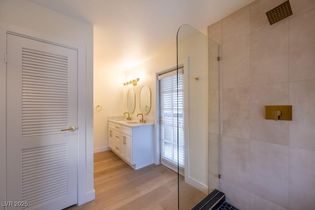 bathroom featuring vanity, hardwood / wood-style flooring, and walk in shower