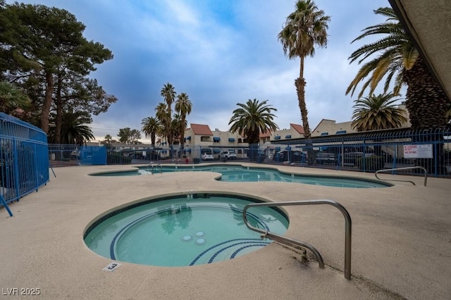 view of pool with a community hot tub and a patio