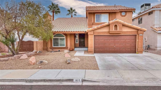 view of front of home featuring a tile roof, fence, driveway, a gate, and stucco siding