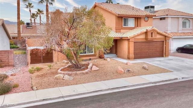 view of front of home with a garage and central AC unit