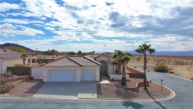 view of front of property with a garage and a mountain view