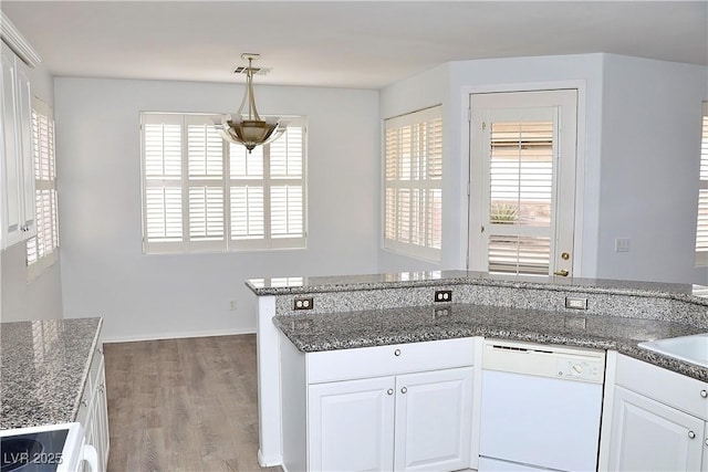 kitchen with white cabinetry, hardwood / wood-style floors, white dishwasher, and decorative light fixtures