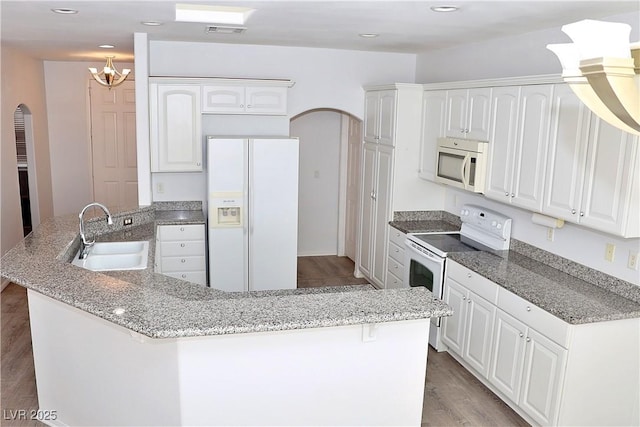 kitchen with sink, white appliances, and white cabinets