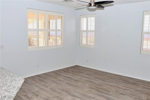 spare room with ceiling fan and wood-type flooring