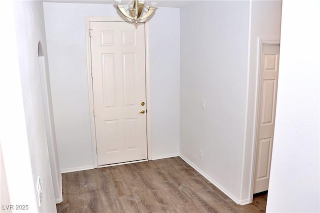 interior space featuring a notable chandelier and hardwood / wood-style flooring