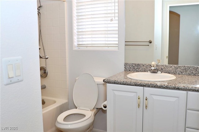 full bathroom with tiled shower / bath combo, vanity, and toilet