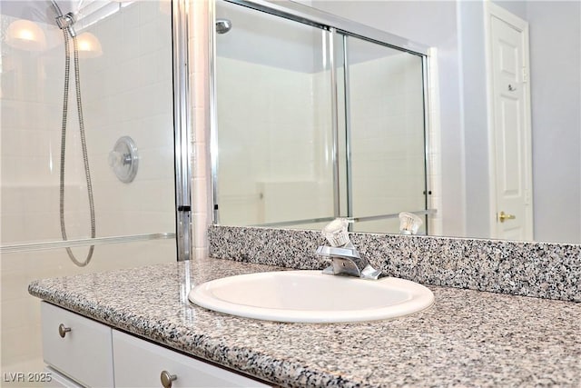 bathroom with vanity and an enclosed shower