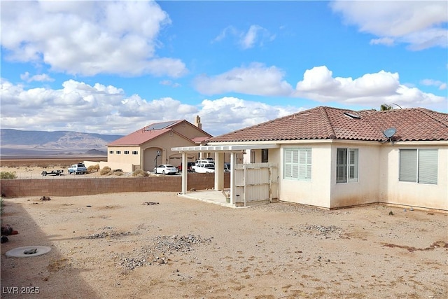 back of property with a mountain view