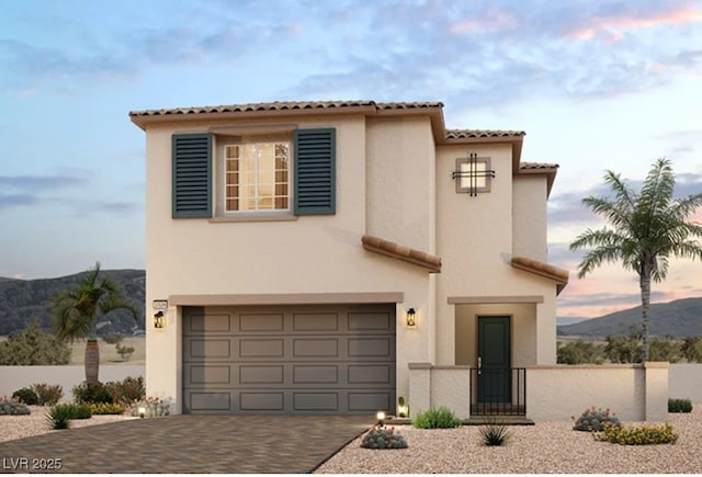 mediterranean / spanish house featuring a mountain view and a garage