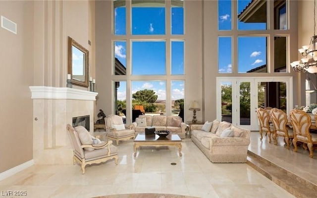 sunroom with an inviting chandelier and a fireplace