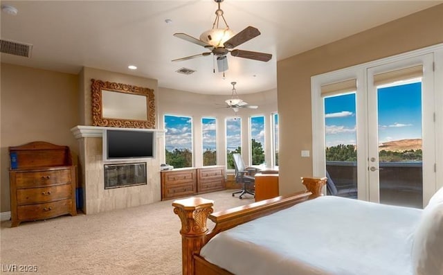 carpeted bedroom featuring french doors, ceiling fan, and access to exterior