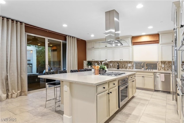 kitchen featuring tasteful backsplash, stainless steel appliances, a kitchen island, and island range hood