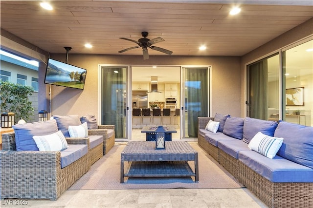 view of patio with outdoor lounge area and ceiling fan