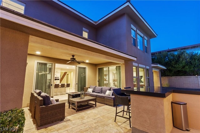 view of patio / terrace featuring ceiling fan, an outdoor living space, and exterior bar