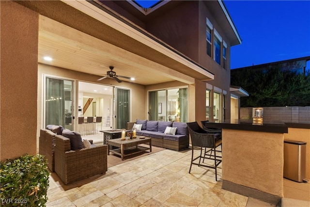 view of patio / terrace with a bar, an outdoor hangout area, and ceiling fan