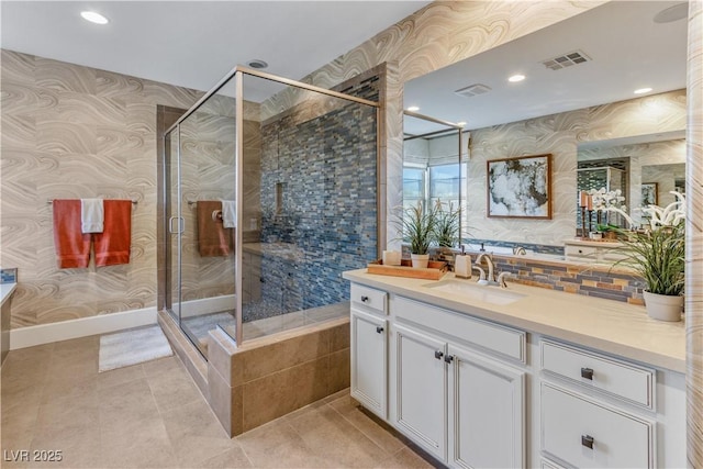 bathroom featuring vanity, an enclosed shower, and tile patterned floors