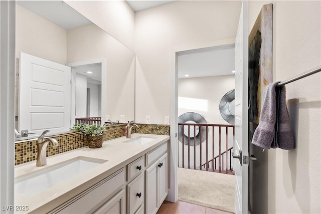 bathroom featuring vanity, tile patterned flooring, and backsplash