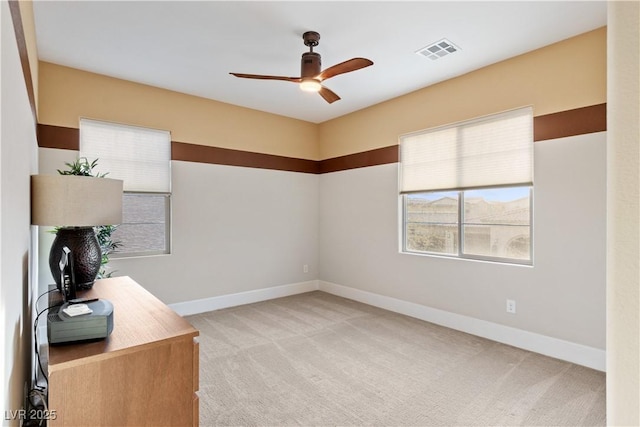 home office featuring light colored carpet and ceiling fan