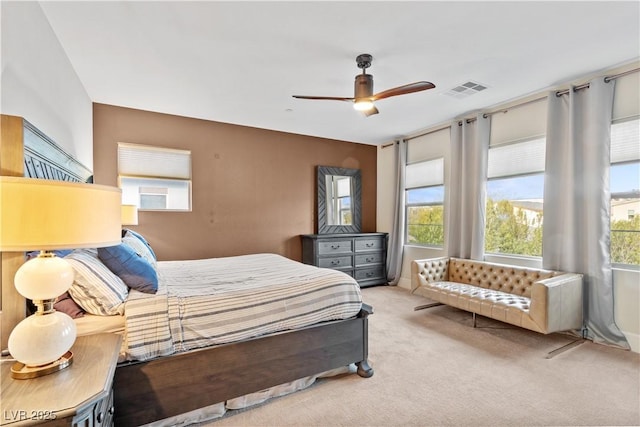 bedroom featuring ceiling fan and light carpet