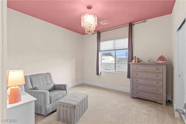 living area with a chandelier and light carpet