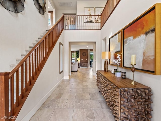 entryway featuring a towering ceiling