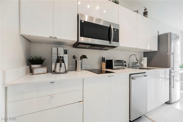 kitchen featuring white cabinetry, sink, and stainless steel appliances