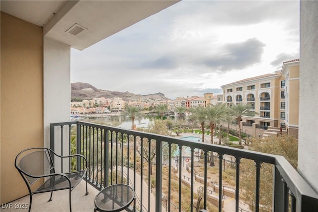 balcony with a water and mountain view