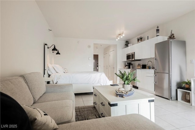 tiled bedroom with stainless steel fridge and a closet