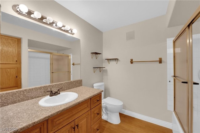 bathroom with vanity, wood-type flooring, and toilet