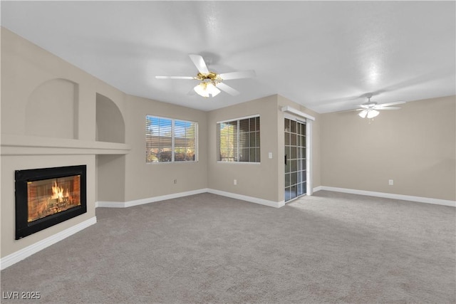 unfurnished living room with ceiling fan and light colored carpet