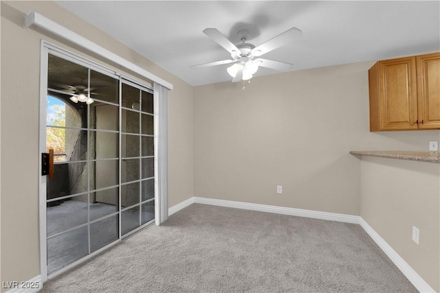 unfurnished room featuring light colored carpet and ceiling fan