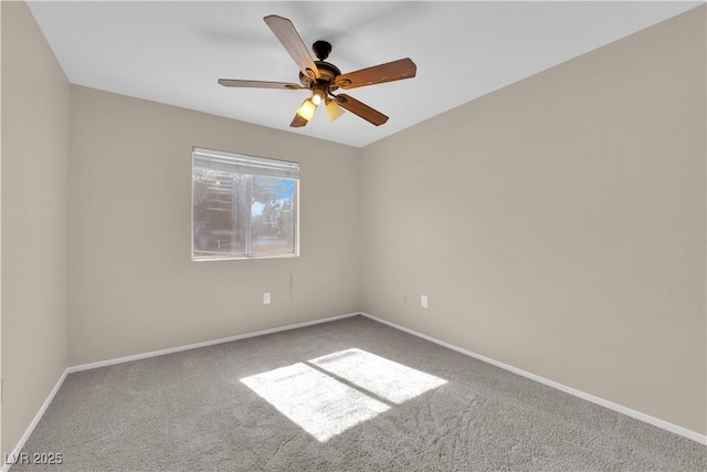 empty room featuring ceiling fan and carpet