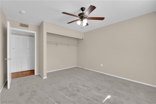 unfurnished bedroom featuring a closet, ceiling fan, and carpet