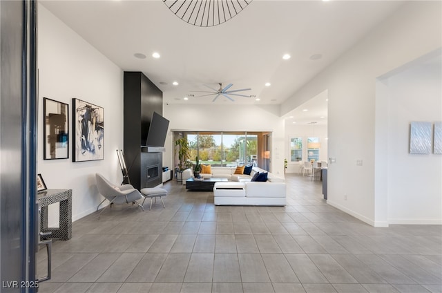 living room featuring ceiling fan and light tile patterned flooring