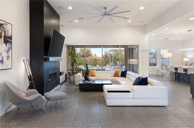 tiled living room with ceiling fan