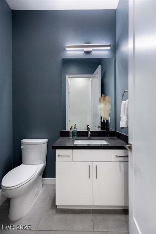 bathroom featuring vanity, tile patterned floors, and toilet