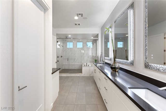 bathroom featuring vanity, tile patterned flooring, and a shower with door