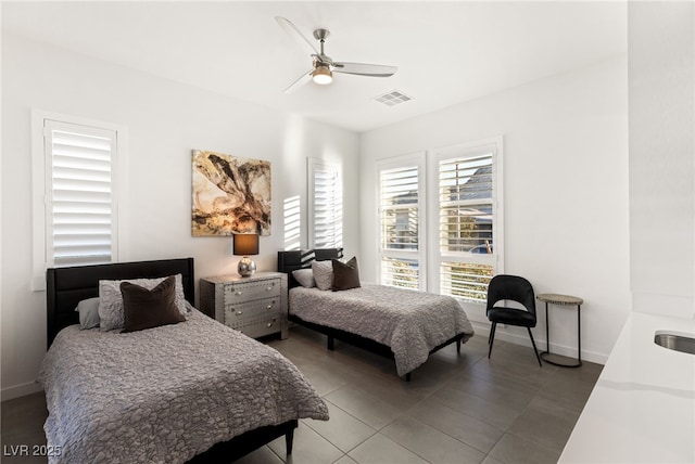 bedroom with ceiling fan and sink