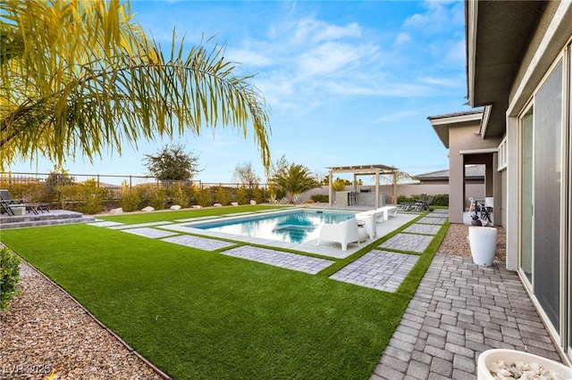 view of pool featuring a yard, a pergola, and a patio