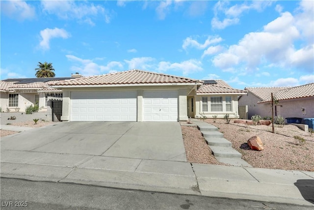 view of front of home with a garage and solar panels