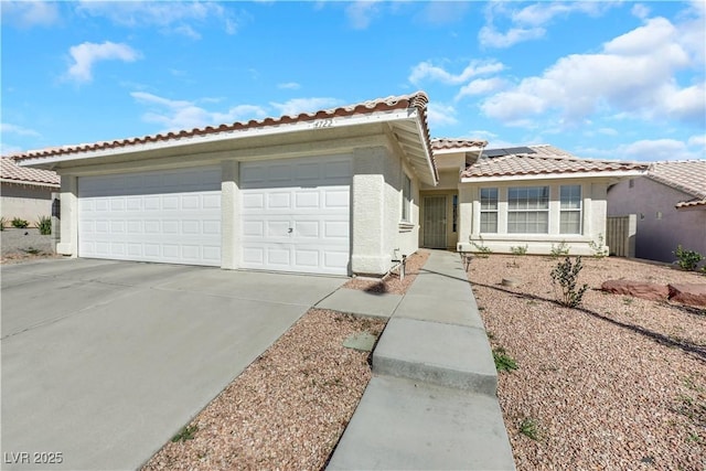 view of front of home with a garage and solar panels