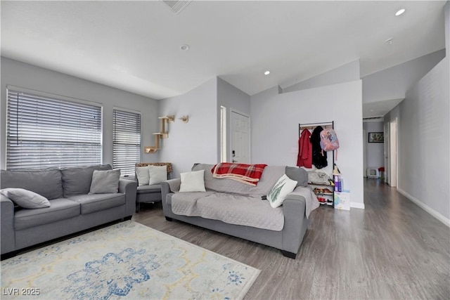 living room featuring lofted ceiling and hardwood / wood-style floors