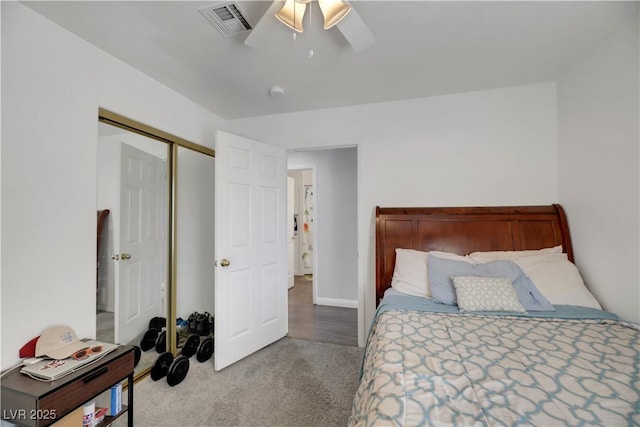 bedroom with light colored carpet, ceiling fan, and a closet