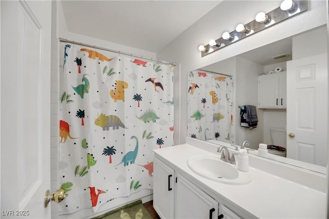 bathroom featuring shower / bath combination with curtain and vanity