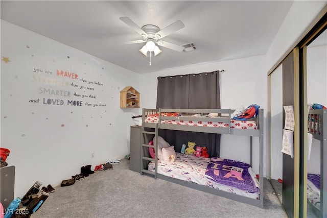 bedroom with a closet, ceiling fan, and carpet