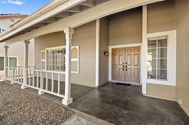 entrance to property featuring a porch