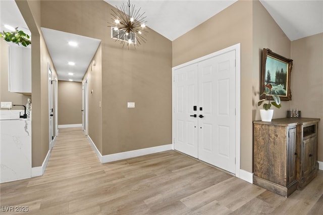 entrance foyer with a chandelier and light hardwood / wood-style flooring